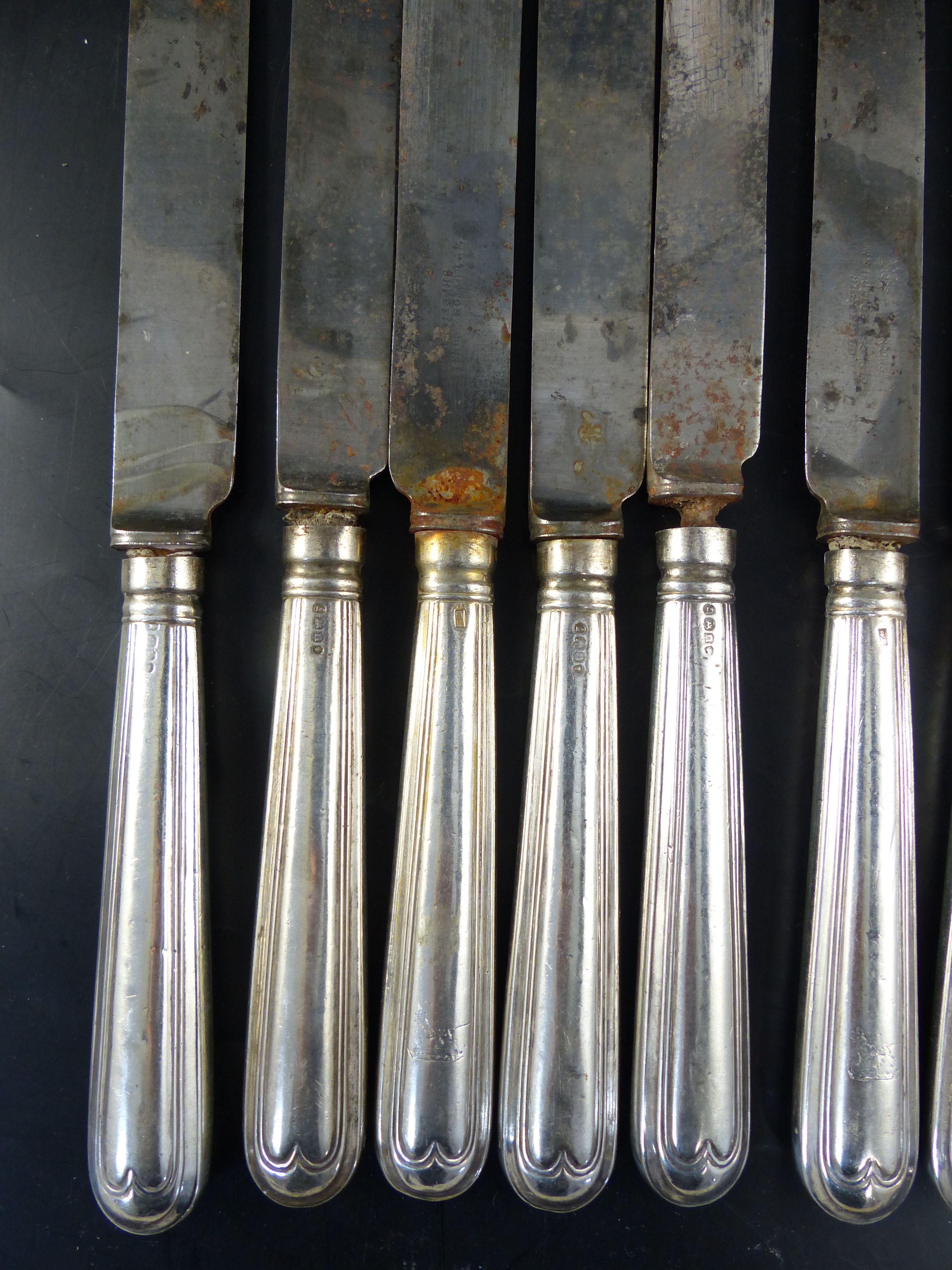A set of twelve George IV silver handled thread pattern table knives,